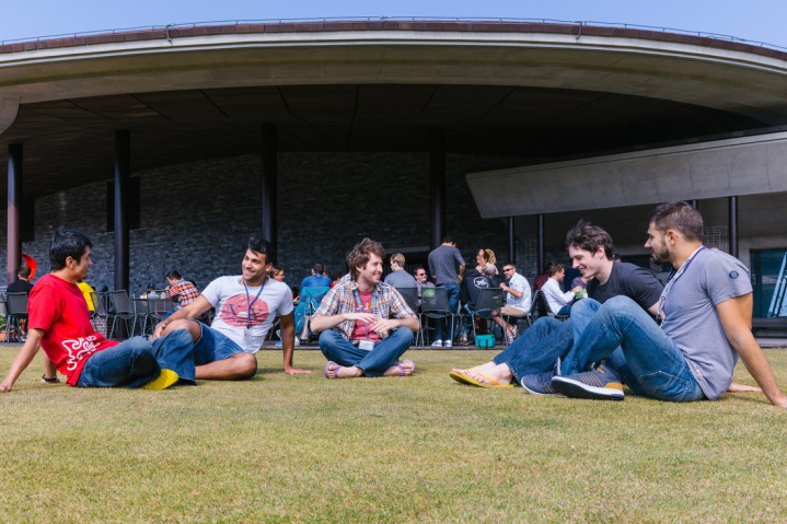 students sitting on the grass