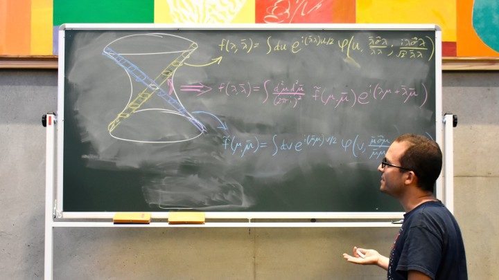 A person in front of a blackboard