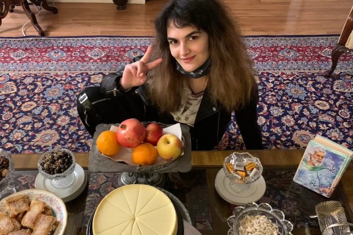 portrait of Samira TAVASSOLI in front of a table with dessert