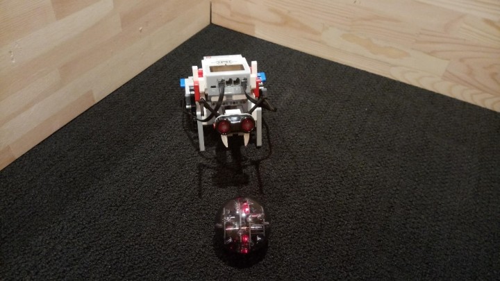 small robot with a clear plastic ball red lights inside