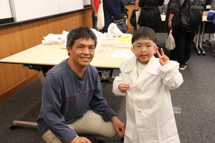 Children put on lab coats and eye protection to look like scientists