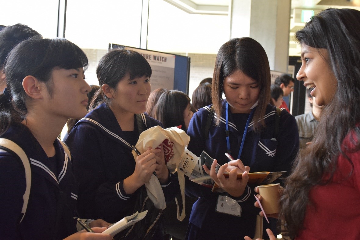 Pravini Wickramanayake from APU (right), speaks with Nago High School students at the ‘Future Watch’ poster session