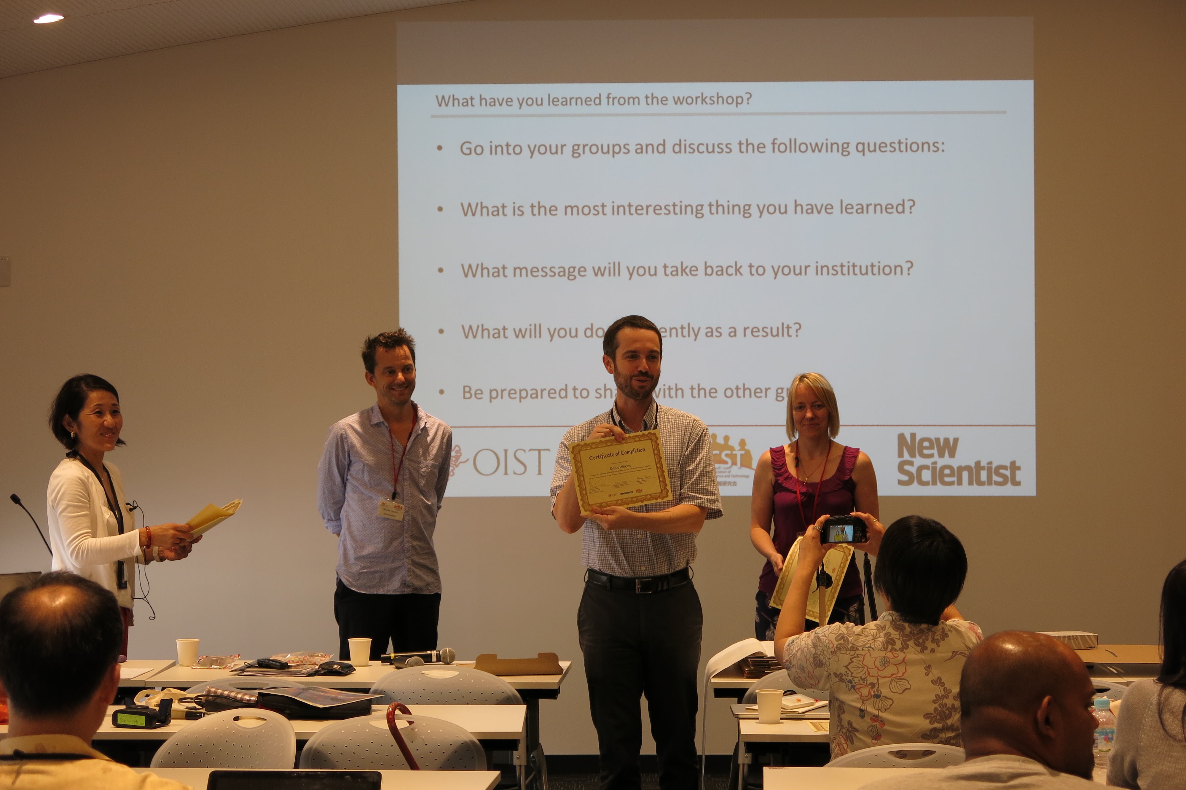 A participant receives his certificate at the ISCW Summer School 2015