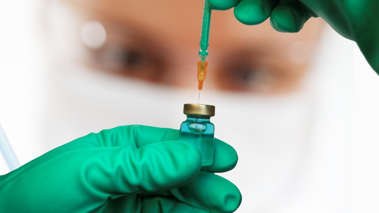 Researcher displays COVID-19 vaccine