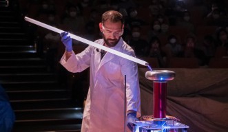 Science experiment show by student Theodoros Bouloumis. Electricity emitted from the Tesla coil lit a fluorescent light.