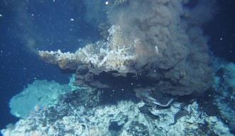 A hydrothermal deep sea vent on the sea floor spurts out hot sea water and toxic metals