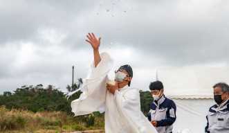 A Shinto priest performs purification rights