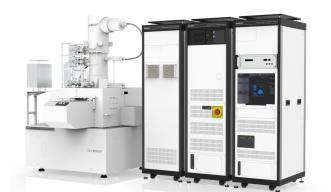 Apparatus which ressembles a column (electron beam housing), with fully enclosed sample area. Right side: control hardware rack (three units side by side).