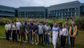 Participants from the Mirror Lab Symposium: Frontiers in Recent Human Evolution gather for a group photo outside of Lab 5.