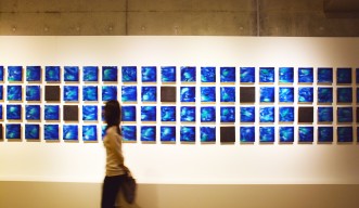 Ishigaki Blue – a visitor walks by the artwork