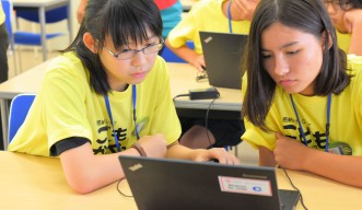 Students programming together