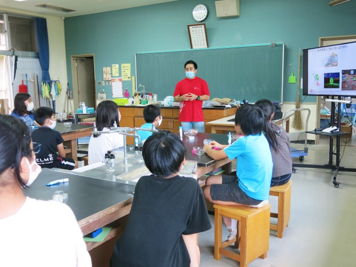 School children listening to an adult speaker in the classroom 
