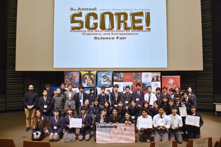 Students in front of a screen projected "SCORE!" text