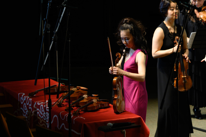 Eiko Kano selects one of the four Strad and Del Gesù violins to play.