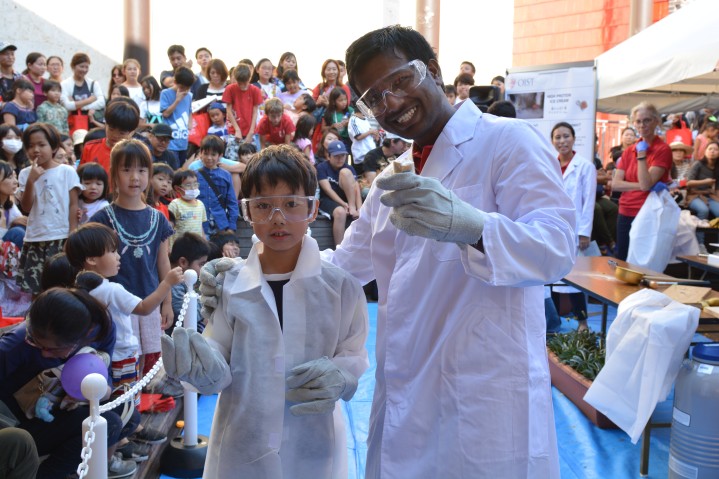 Scientist and a boy in white coat