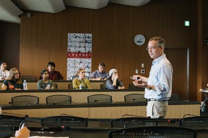 people in a conference room listening to a speaker