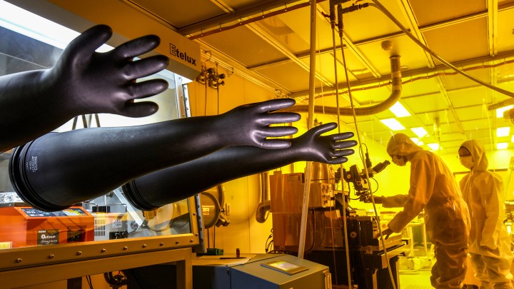 scientists in protective suits in a lab