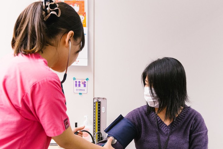 lady measuring a pacient's blood pressure