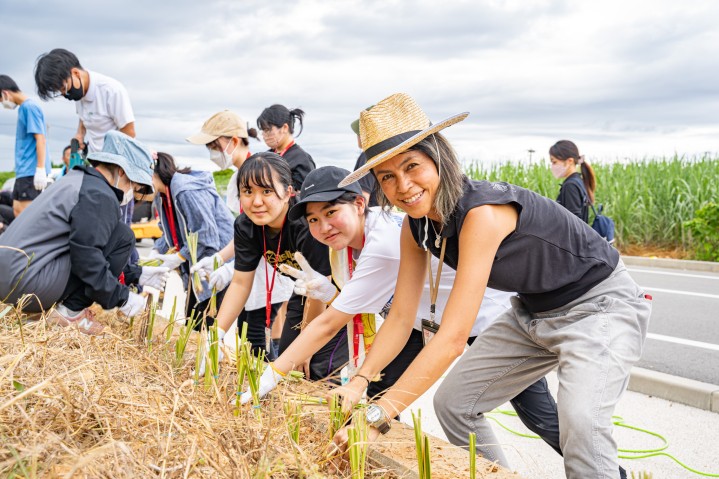 Students and adults planting