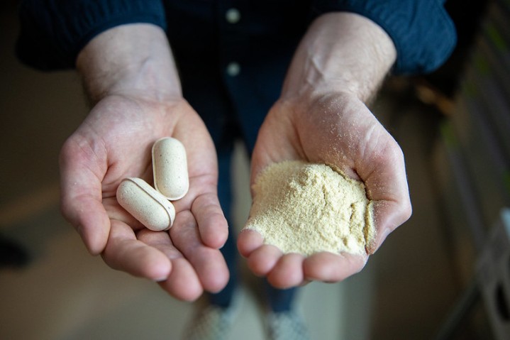 pills and powder on 2 hands