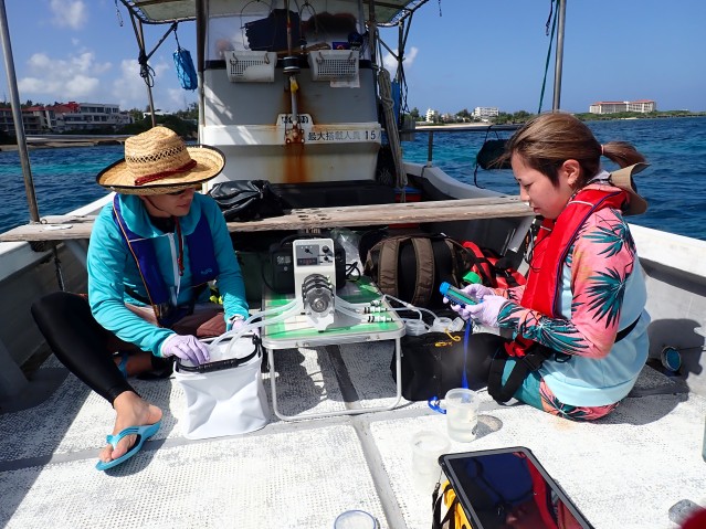 Scientists examines eDNA on a boat