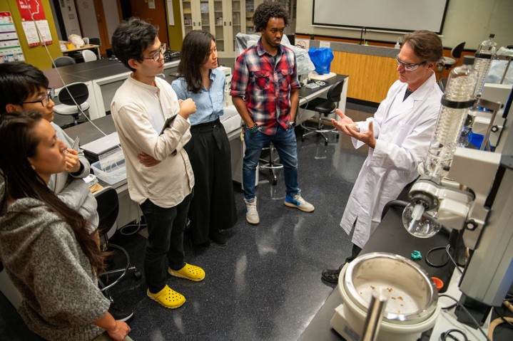 Scientist talking to visitors in a lab