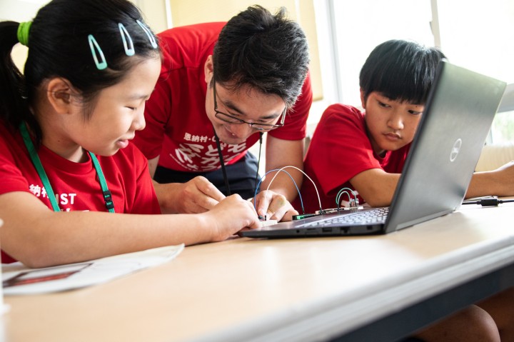 Children around computer at Outreach event