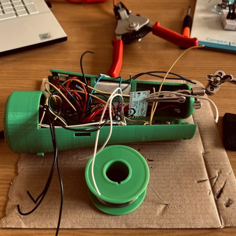 opened torch with wires coming out from inside