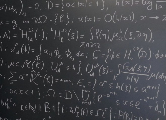 blackboard full of mathematical formulae