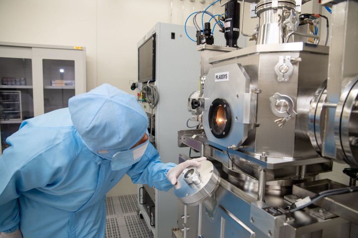 Staff doing a deposition run on a sample in a chamber within a cleanroom