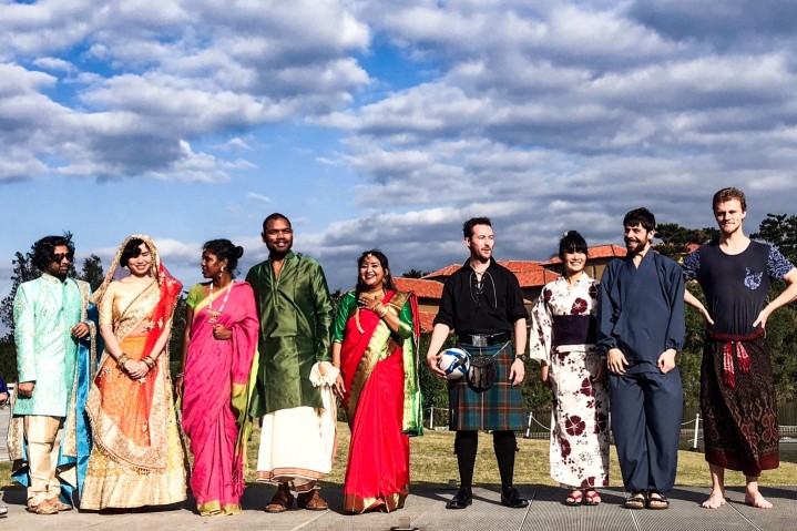 Student club activities. 9 students in traditional clothes.