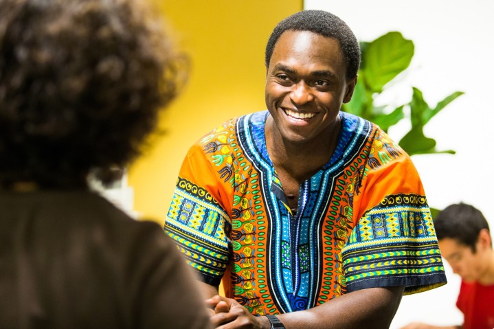 A student smiling at a desk