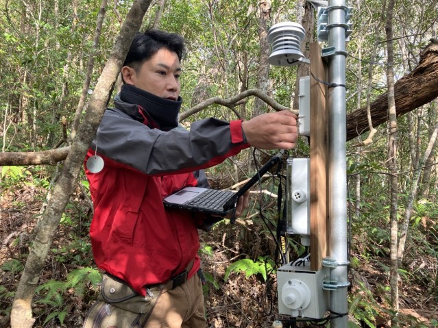 Field team downloading weather station data