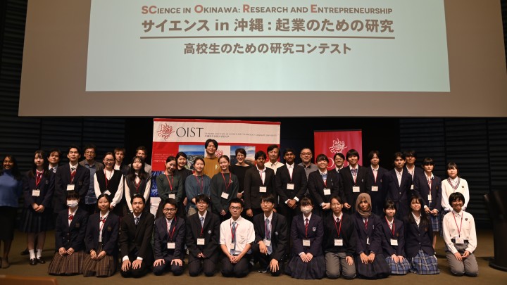 Group photo of high school students, their teachers, and the judges of the 13th annual SCORE! competition on the main stage.