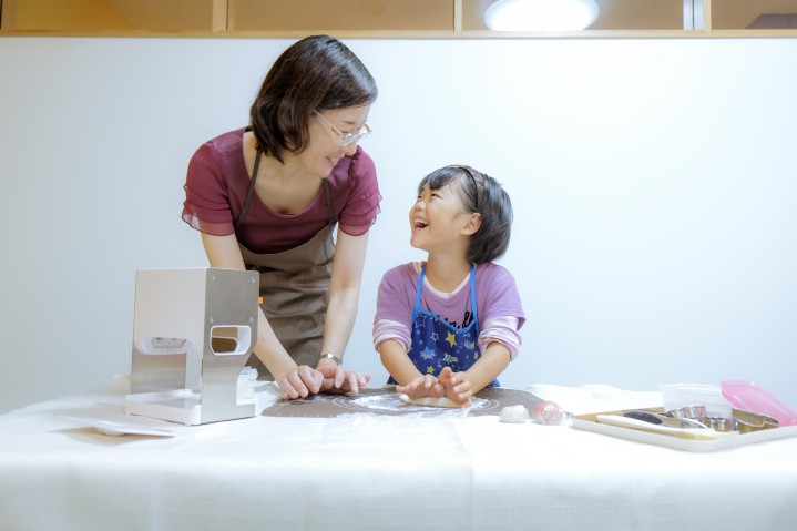 Adult and child smile at each other