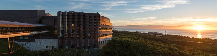 OIST's lab 2 on the left with the ocean and sunrise from the right side