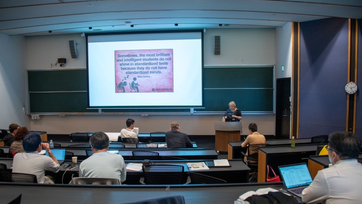 auditorium with slide stating that sometimes the most brilliant and intelligent students do not shine in standardized tests because they do not have standardized minds