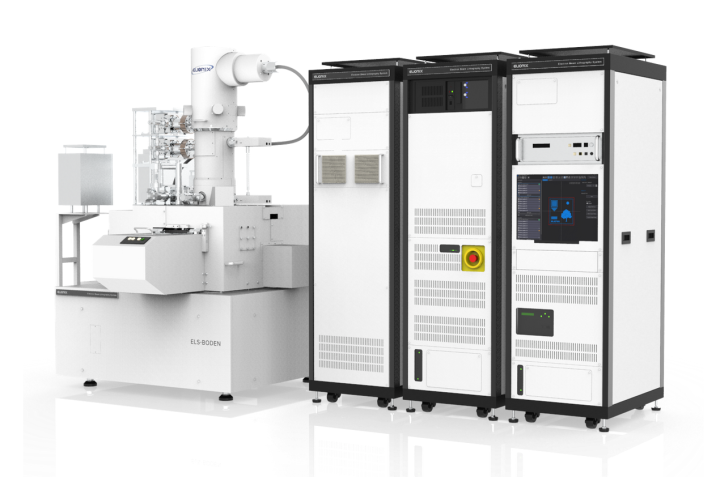 Apparatus which ressembles a column (electron beam housing), with fully enclosed sample area. Right side: control hardware rack (three units side by side).