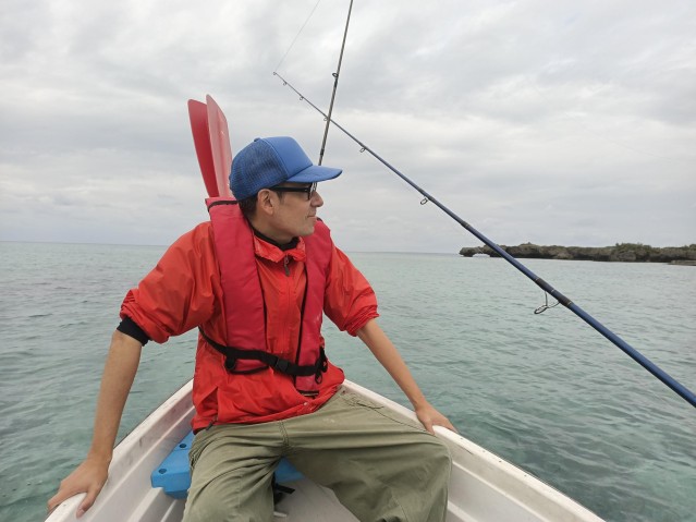 Camilo on the fishing boat looking at the ocean