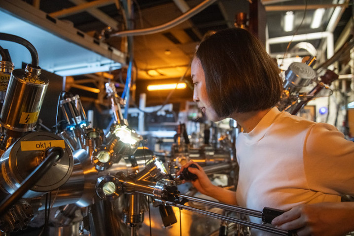 A researcher working in a lab in front of a machine