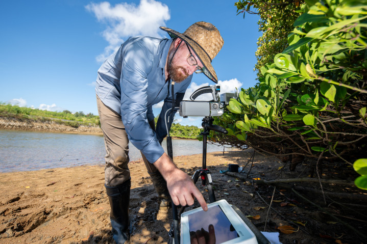David Armitage at the beach working with research equipment