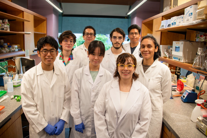 Keio students stand with members of the Toledo-Patino Group researchers inside the Molecular Bioengineering Lab at OIST.
