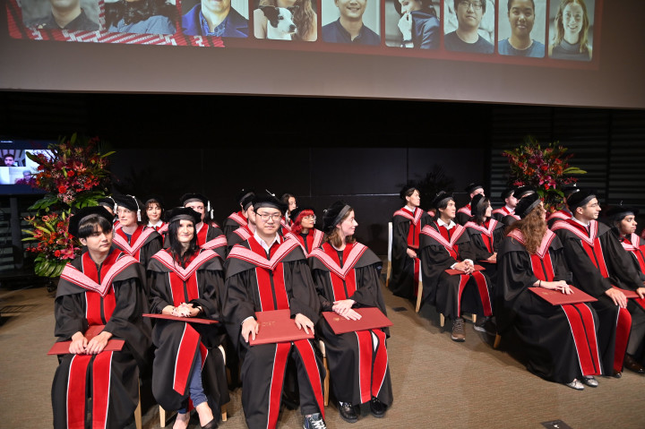 Graduating students sitting in front of the auditorium