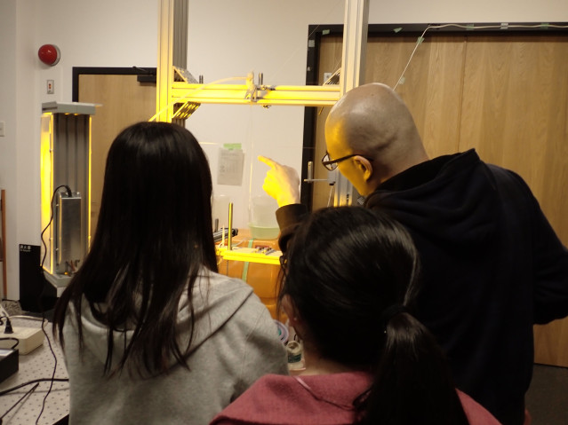 Soda showing students a soap film.