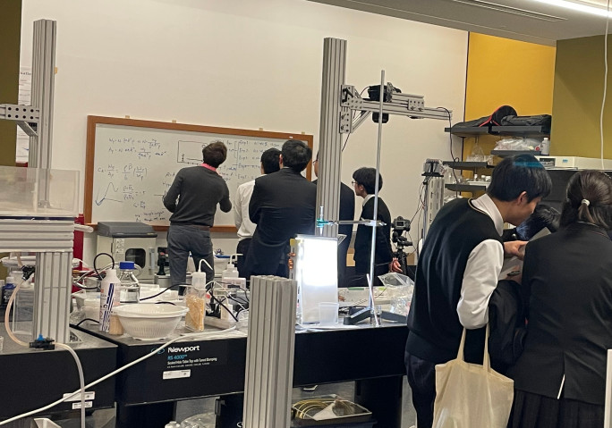 Jack writing on a white board in front of students.