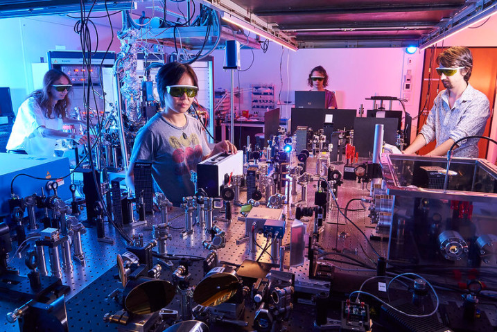Scientists working in a lab surrounded by machines