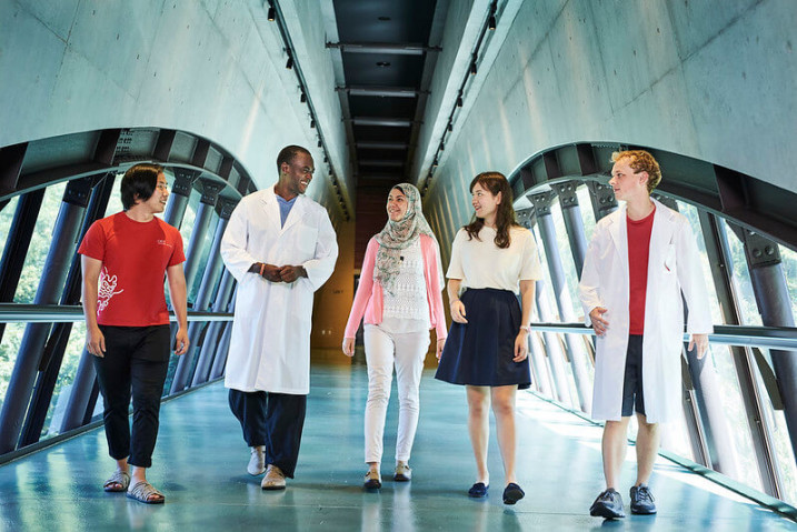 5 people walking in a corridor