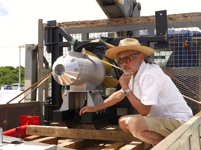 A man sitting in front of a machine