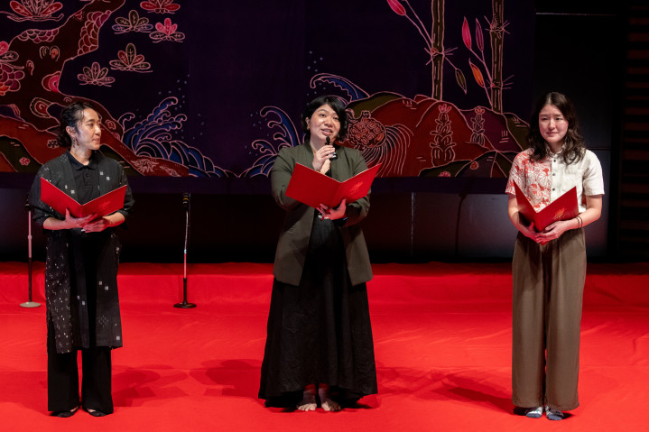 Three staff members from OIST are talking on the stage.