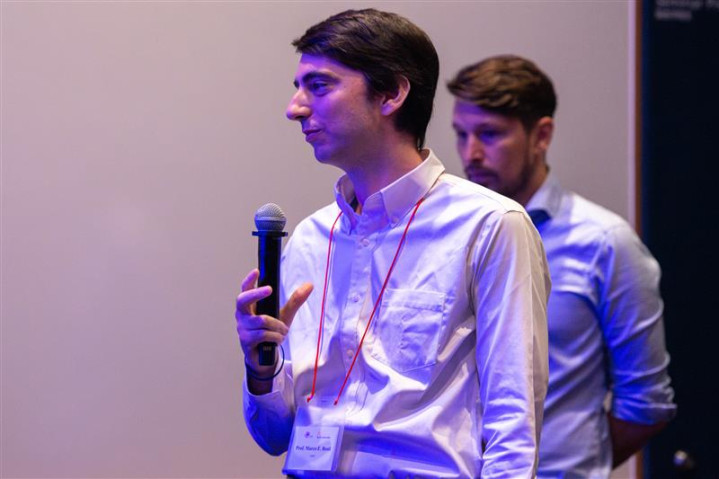 Professor Marco Edoardo Rosti delivers a short talk during the Showcase Talk 10, presenting ongoing research to attendees gathered in the seminar room.